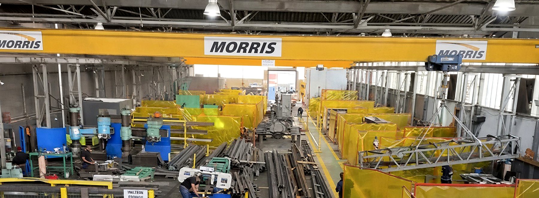 Matcheck shop floor with overhead crane, machining area, raw stock and welding bays