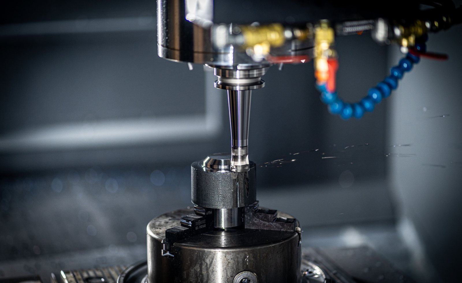 CNC machining centre spindle and tool over a workpiece
